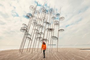 girl-tourist-explores-sculpture-flying-umbrellas-sea-promenade-thessaloniki-greece_984126-6866