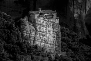 monastery-holy-trinity-rock-surrounded-by-forests-hills-sunlight-greece_181624-19010