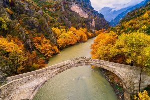 Aerial view of Konitsa old bridge and Aoos River an autumn day, Greece.